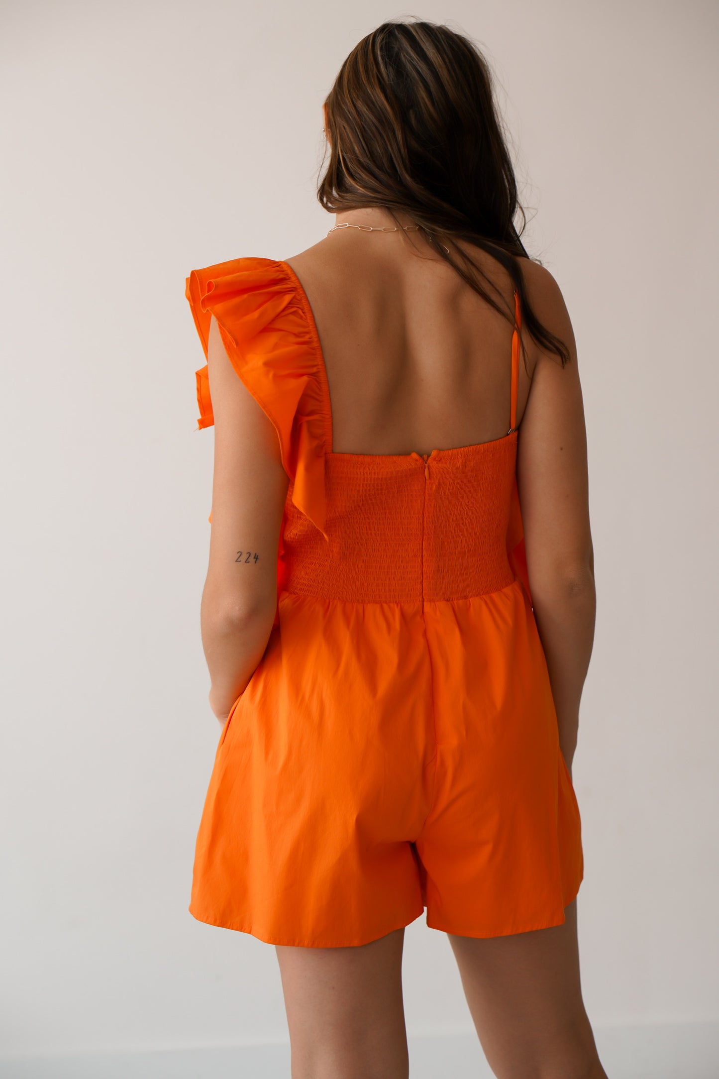 Up close of the zipper and smocking in the back