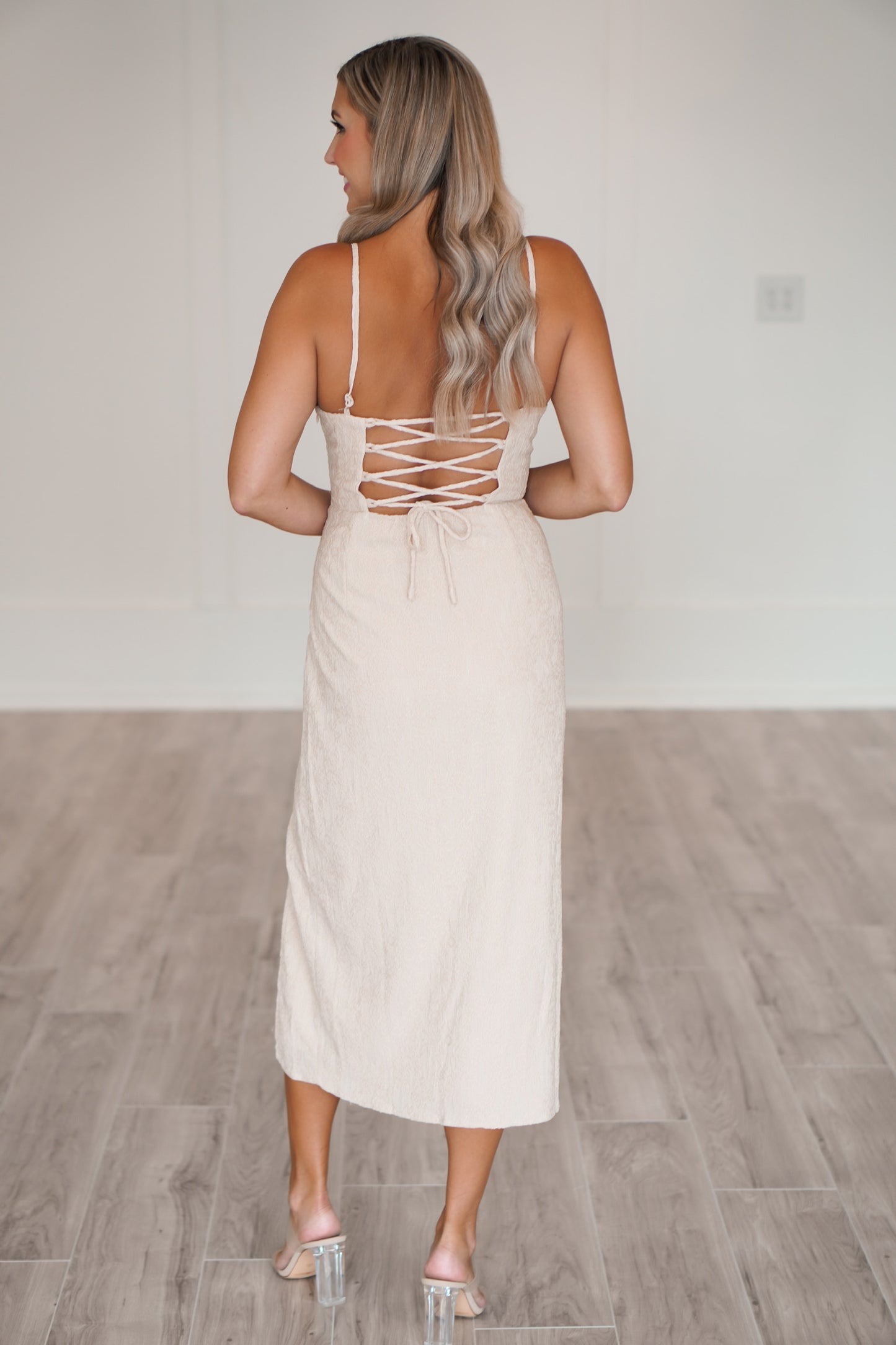 showing off the adjustable straps and the ties in the back