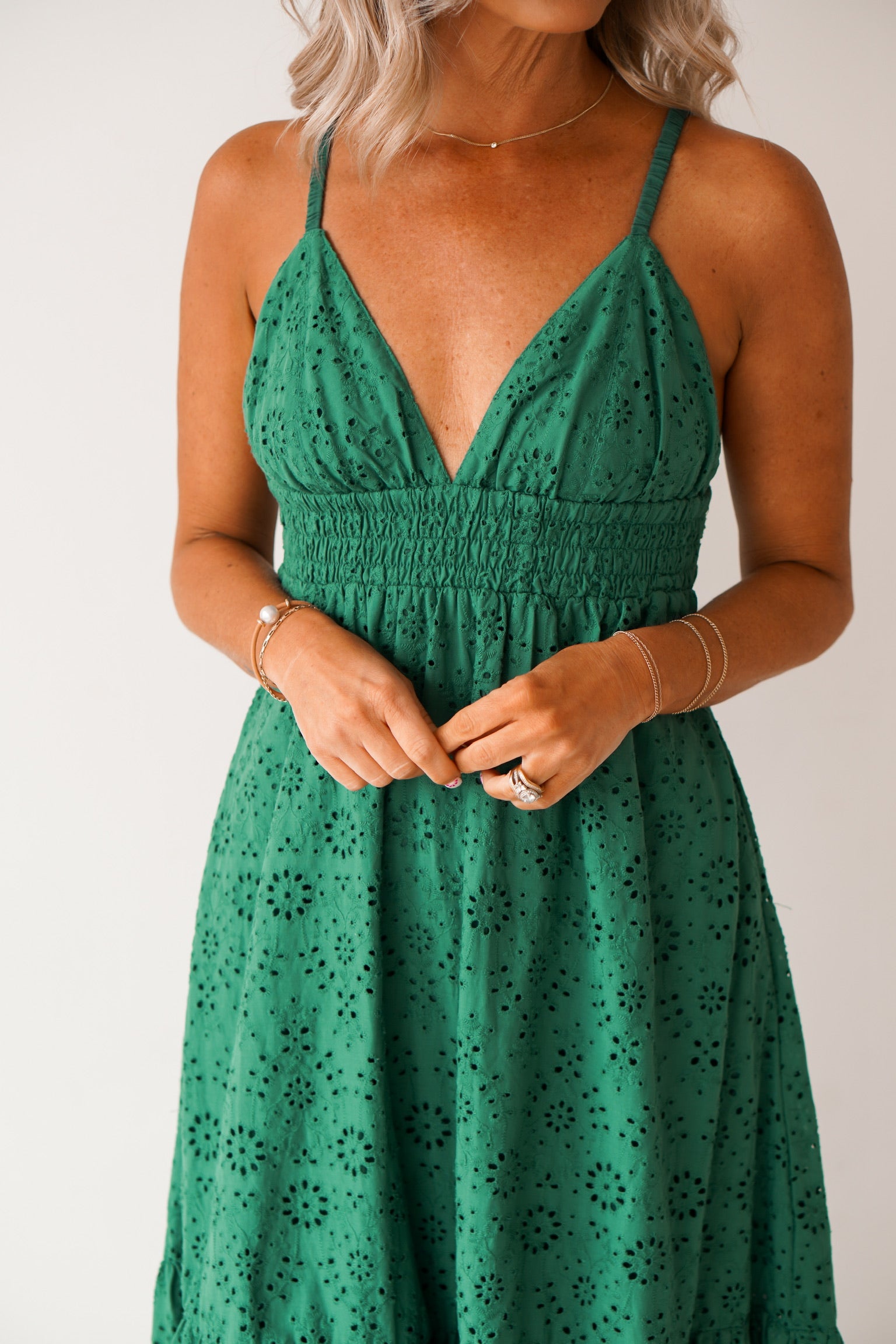 showing an up close of the v neck on the green maxi dress