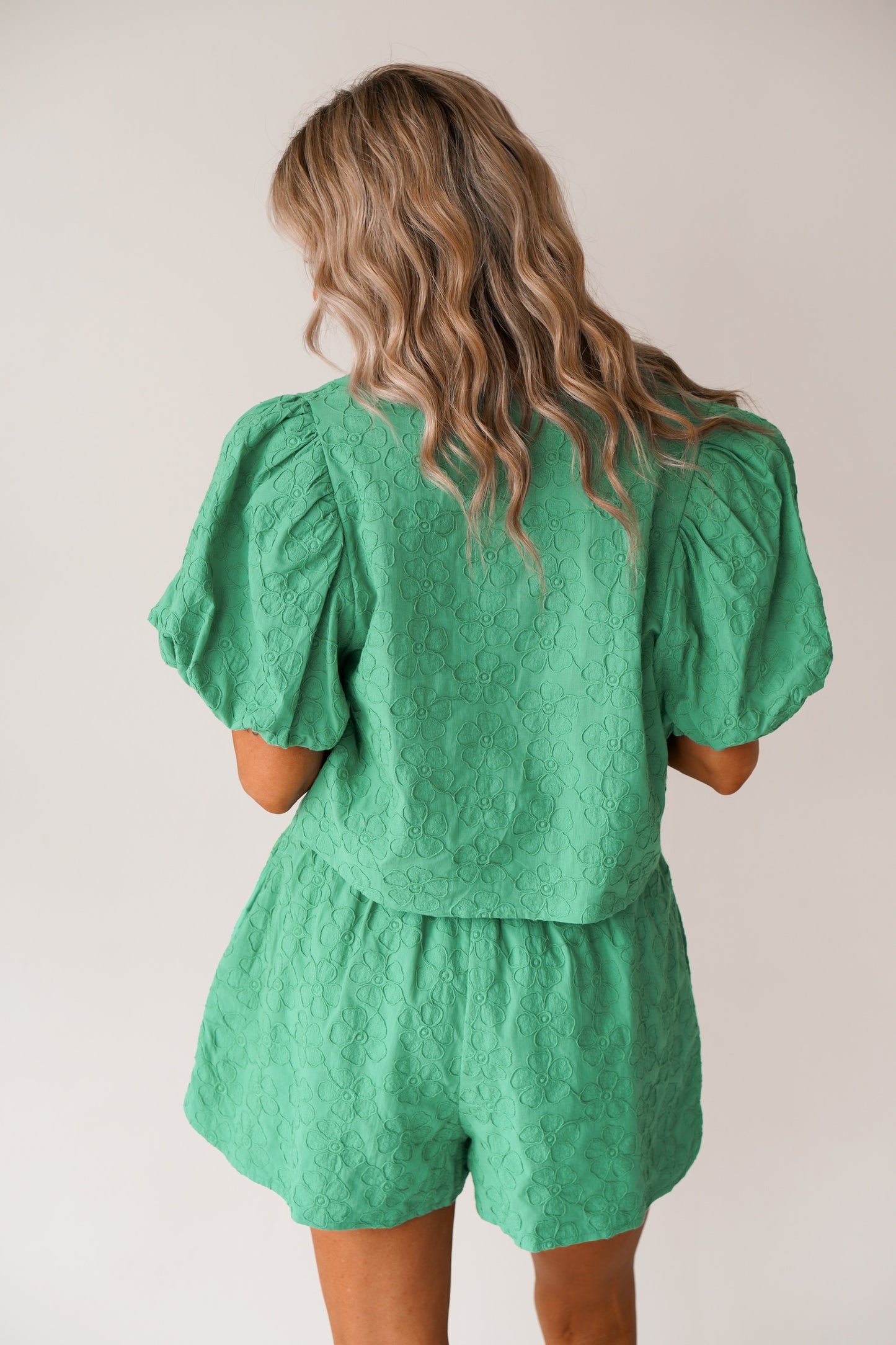showing the back of the green set which has bubbled sleeves